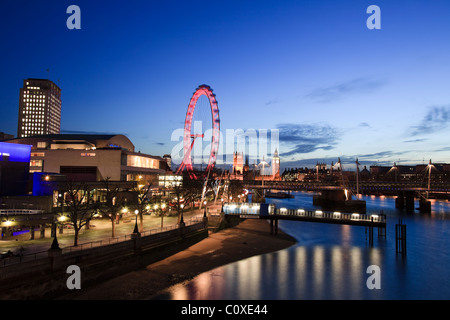 London Eye,Millennium Wheel, at Dusk with Big Ben and the Houses Of Parliament in the background, London, England, UK Stock Photo