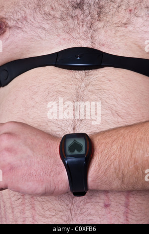 Fat man preparing to workout, adjusting heart rate monitor Stock Photo