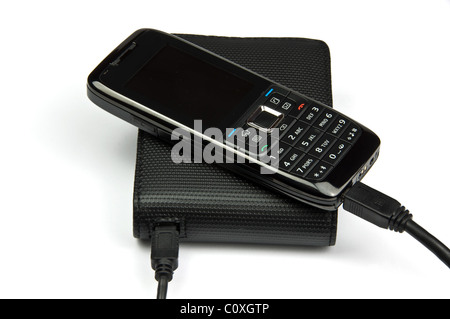photo of mobile phone connected to external hard drive Stock Photo