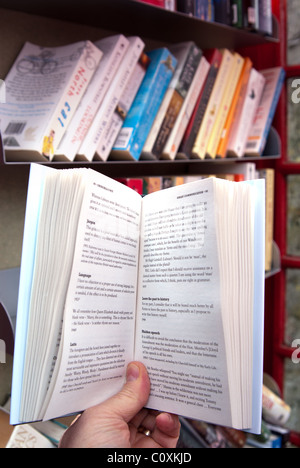 A UK village's redundant BT red telephone box now adopted by the parish council, and converted into a 'Bookswap' mini library. Stock Photo