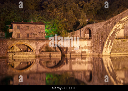 Colors and Reflections of Devils Bridge at Night, Italy Stock Photo