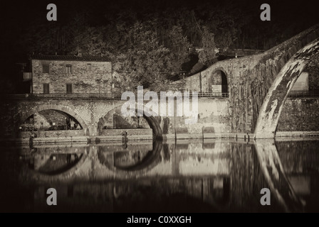 Colors and Reflections of Devils Bridge at Night, Italy Stock Photo