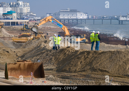 Site Managers Monitoring Beach Restoration Works at Eastbourne, East Sussex, UK Stock Photo