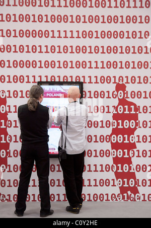 Binary code and people in front of a screen Stock Photo