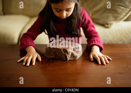 Girl with large brick of chocolate Stock Photo