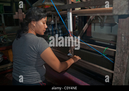 Woman doing traditional ikat weaving in the aboriginal Aga village of Tenganan in eastern Bali Stock Photo