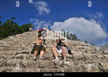 Tourists climbing the Nohoch Mul pyramid at the Mayan ruins of Coba Yucatan Mexico Stock Photo