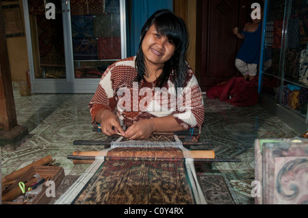 Woman doing traditional ikat weaving in the aboriginal Aga village of Tenganan in eastern Bali Stock Photo