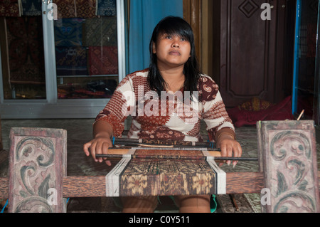 Woman doing traditional ikat weaving in the aboriginal Aga village of Tenganan in eastern Bali Stock Photo