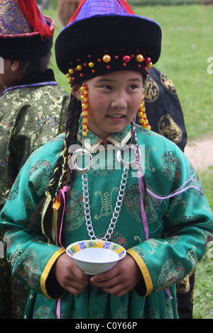 Girl in the Buryat national costume on a summer nature at folklore festival in Pushkinskiye Gory. Pskov Region, Russia Stock Photo