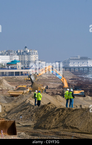 Site Managers Monitoring Beach Restoration Works on the seafront at Eastbourne, UK Stock Photo