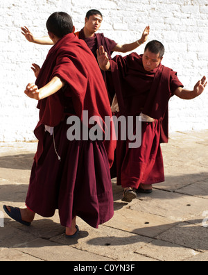 Bhutanese monk(s) practicing dance steps prior to appearing in a major religious festival. Stock Photo