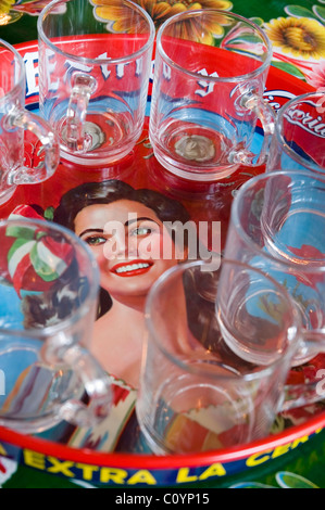 Glass teacups on a vintage mexican beer tray Stock Photo