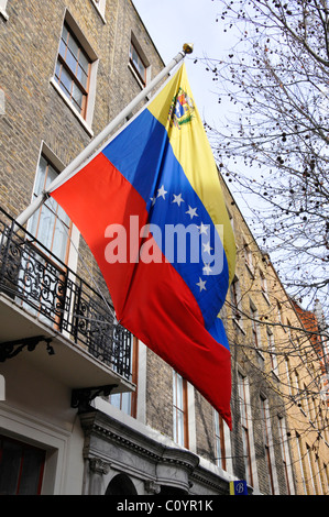 Street scene close up Venezuelan flag flying on the front façade above the consulate entrance Grafton Street London England UK Stock Photo