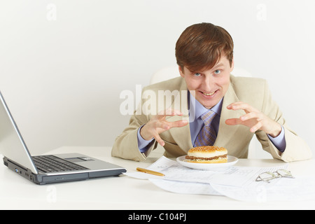Young hungry man is going to eat a sandwich Stock Photo
