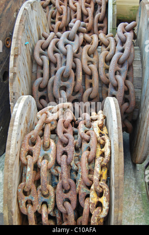 large metal chains on wooden spools Stock Photo