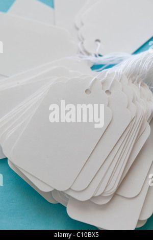 white blank price tag with string on blue cost Stock Photo