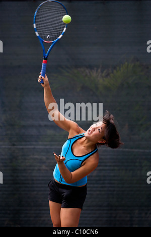 Japanese teenage tennis player in action. Stock Photo