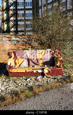 Urban Fly Tipping a Sofa or Couch  urban decay inner city Stock Photo