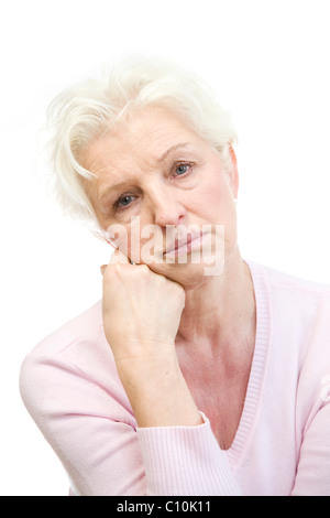 A mature woman looking depressed, resting her head on her hand Stock Photo