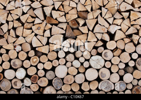 Firewood, stacked roundwood, logs on top, front side of the stack Stock Photo