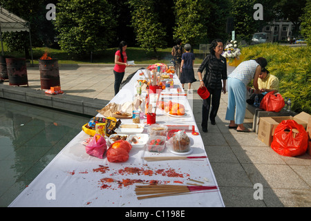 Food set out for the dead by Buddhists at  The Memorial to the Victims of the Japanese Occupation in Singapore Stock Photo