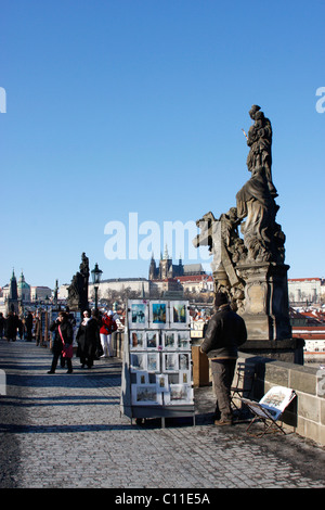 An artist offering his photographs of Prague to tourists along the Charles Bridge in Prague,Czech Republic. Stock Photo