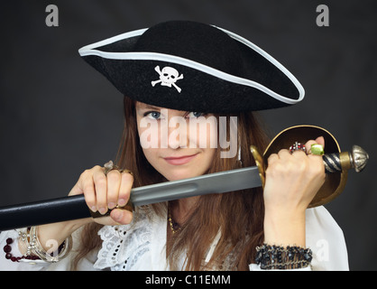 Portrait of woman - pirate getting sabre from a sheath Stock Photo