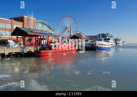 Ice begins forming in the harbor near Navy Pier and the ships tied up at its moorings on a cold December day. Chicago Illinois, USA. Stock Photo