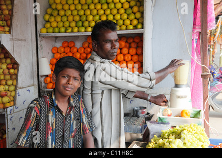 Father and son in a fruit shop with juice mixer, Punjaipuliampatti, Tamil Nadu, Tamilnadu, South India, India, South Asia, Asia Stock Photo