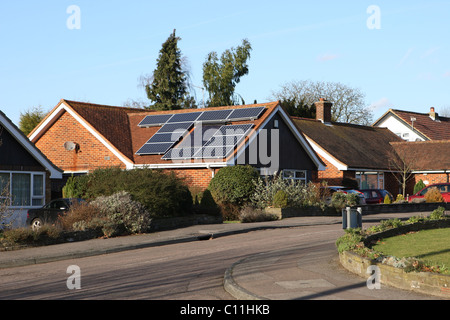 Solar power panels on the roof of a residential house / bungalow in the UK. Stock Photo