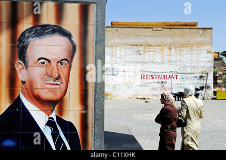 Tiles with a portrait of former President Hafez al Assad, and women with headscarves, Bosra, Syria, Asia Stock Photo