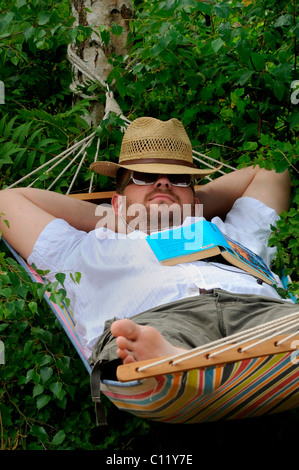 Man sleeping in a hammock Stock Photo