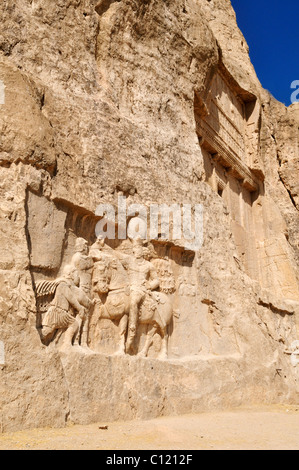 Historic Sassanid relief of the triumph of King Shapur I. over the Roman Emperor Valerian and Philip the Arab and tomb of King Stock Photo