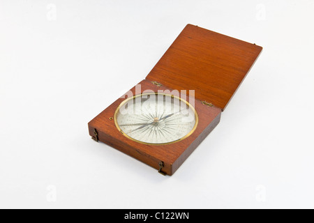Old marine compass encased in wood Stock Photo
