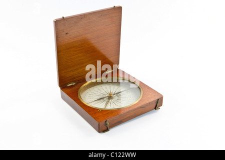 Old marine compass encased in wood Stock Photo