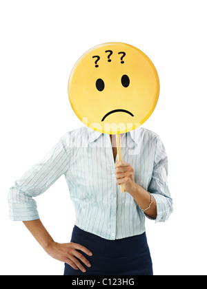 adult business woman holding emoticon with question marks on white background. Vertical shape, waist up Stock Photo