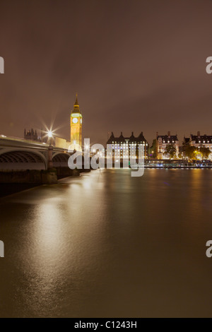 A dramatic night view of Westminster Bridge and 'Big Ben' in London. Portcullis House can also be seen on Victoria Embankment. Stock Photo