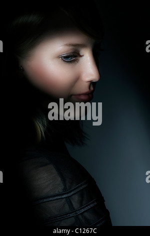 Side portrait of a young woman looking down Stock Photo