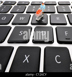 Miniature figure with cart on keyboard, euro symbol, symbolic picture for online shopping Stock Photo