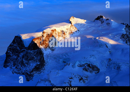 Monte Rosa Mountains with the highest mountain in Switzerland, Pointe Dufour, in the light of the setting sun, Zermatt, Valais Stock Photo