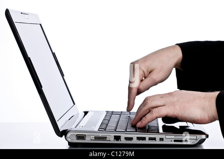 Hands on laptop computer keyboard Stock Photo