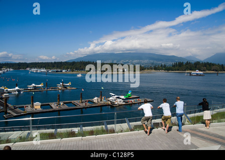 People watching float planes in Vancouver Harbour Stock Photo