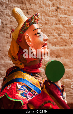 Bhutanese monk dressed in a festival costume who is preparing to dance holding a drum Stock Photo