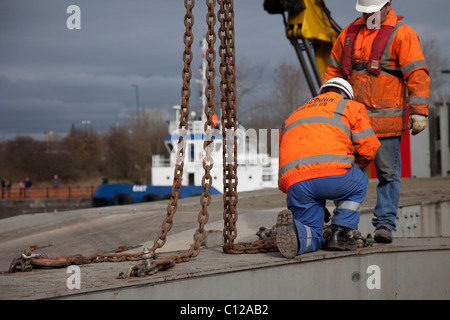 Crane security lifting chains in use during the unloading, & Delivery of Alstom National Grid Transformer, Holme Road, Preston from the barge Terra Marique on the River Ribble, Lancs, UK Stock Photo