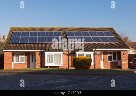 Solar panels on the roofs of semi-detached bungalows in Beccles , Suffolk , England , Britain , Uk Stock Photo