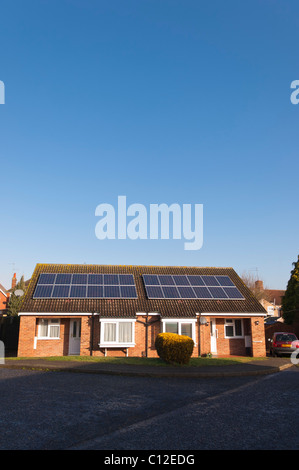 Solar panels on the roofs of semi-detached bungalows in Beccles , Suffolk , England , Britain , Uk Stock Photo