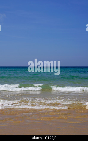 Waves rolling up sandy beach, at Watergate Bay, North Cornwall, England ...