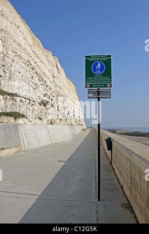 The Undercliff Walk at Ovingdean near Brighton with sign warning cyclists to look out for pedestrians Stock Photo