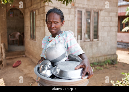 Portrait of Keralite woman with her washing up outside her home, the backwaters, Kerala, India Stock Photo